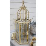 A hexagonal brass and bevelled glass hall lantern, 70 cms high,