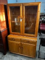 An Ercol elm 'Windsor' glazed side cabinet, width 91cm, depth 43cm, height 162cm