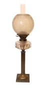 An Edwardian brass column oil lamp with cut glass reservoir, ANCS mechanism and etched shade, height