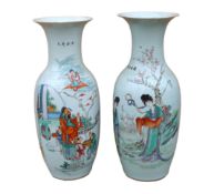 A pair of Japanese polychrome decorated porcelain baluster vases decorated with figures in