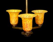 A 1930s GLC bronzed metal light fitting with three marbled amber glass shades, height 60cm. width