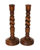 A pair of carved wood barley twist candlesticks, height 46cm