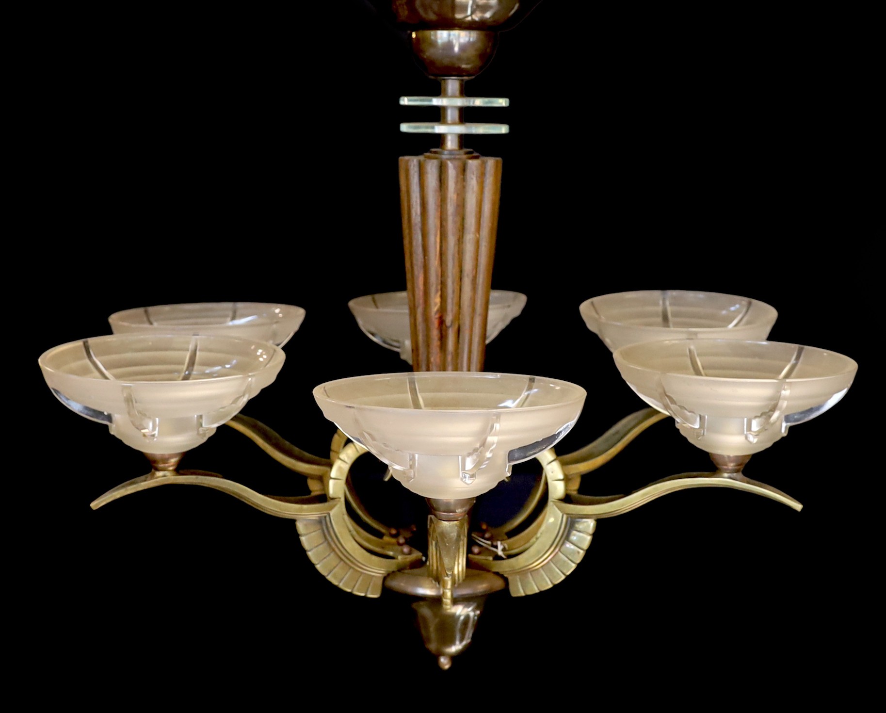 A French Art Deco bronze, hardwood and frosted glass six light chandelier, in the manner of Henri