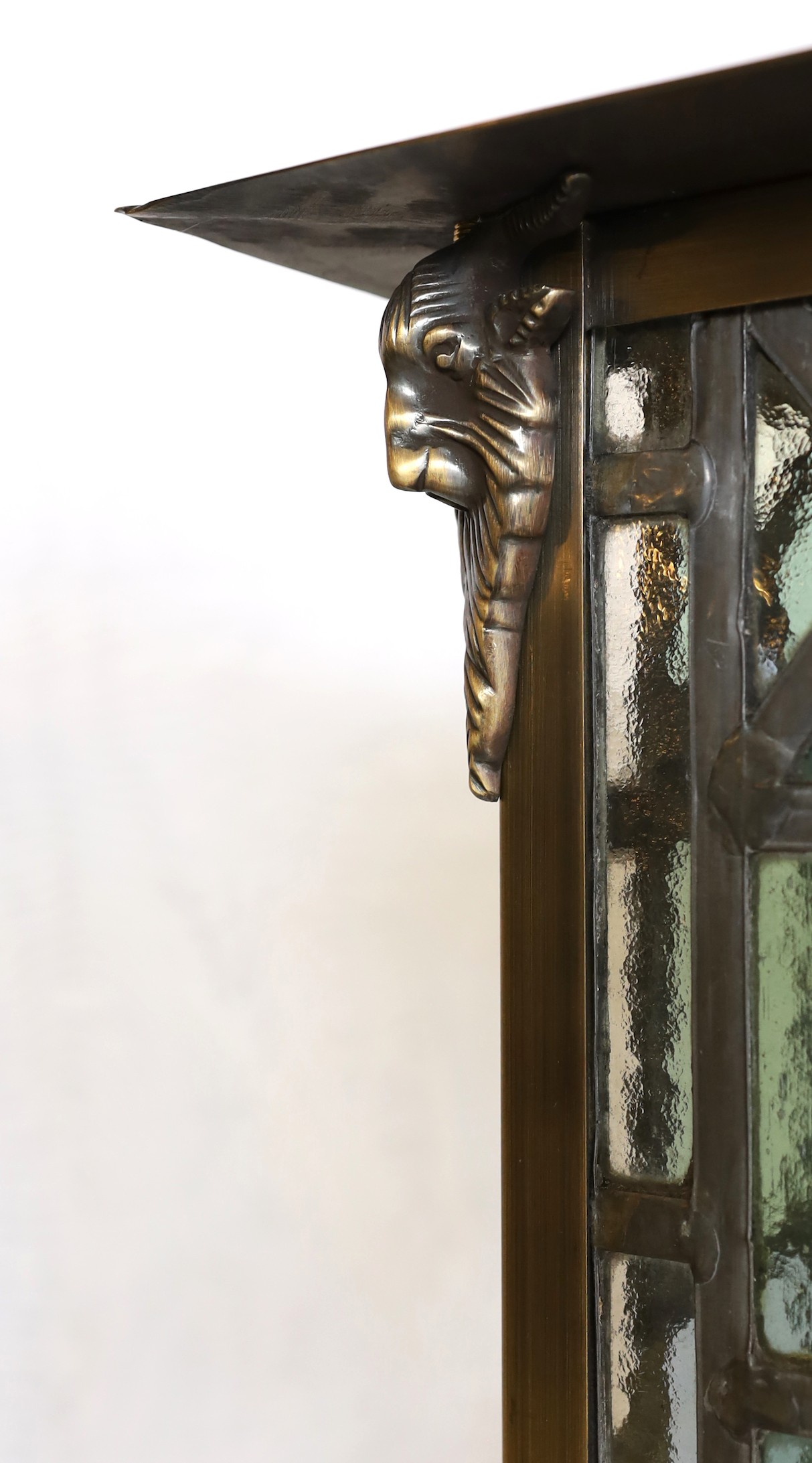 A large Edwardian lacquered brass and leaded glass hall lantern applied with rams head motifs, - Image 3 of 4