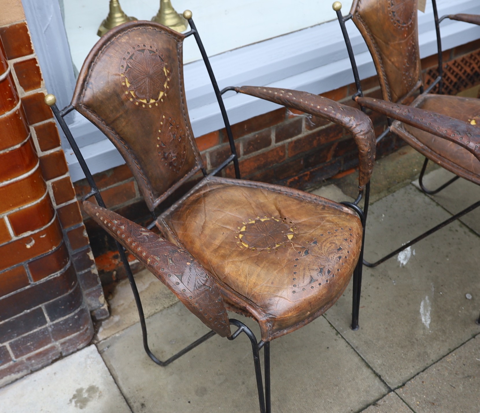 A set of six French wrought iron and brown leather elbow chairs, with brass ball finials, four - Image 4 of 5