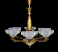 A French Art Deco bronze and opalescent glass six light chandelier by Ezan, with scrolling
