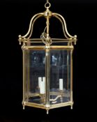 A large Georgian style hexagonal brass hall lantern with bevelled glass plates, height 79cm. width