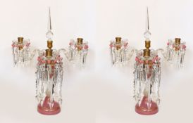A pair of Victorian opaque pink and white glass lustre candelabra, with spear shaped finials and cut