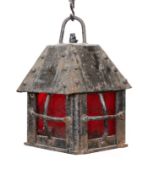 An early 20th century English wrought iron lantern with a red glass panels, height 29cm. width