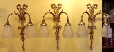 A set of three early 20th century English gilt metal twin branch wall lights with frosted glass