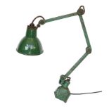 A green painted and enamelled metal adjustable workbench lamp, height 37cm to the bend