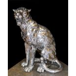 A silvered composition model of a seated leopard, height 50cm