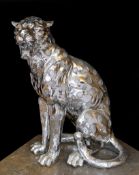 A silvered composition model of a seated leopard, height 50cm