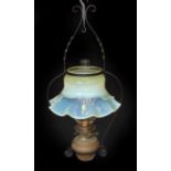 An English Arts & Crafts wrought iron and brass hanging oil lamp with Messengers mechanism and