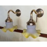 A pair of 1930s French lacquered brass wall lights with yellow tinted quilted and frosted glass