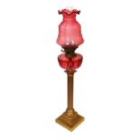 A Victorian lacquered brass fluted column oil lamp with cut ruby glass reservoir, Hinks No2