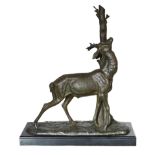 A 1930s French bronzed spelter and marble model of a deer standing beside a tree trunk, signed Cham,