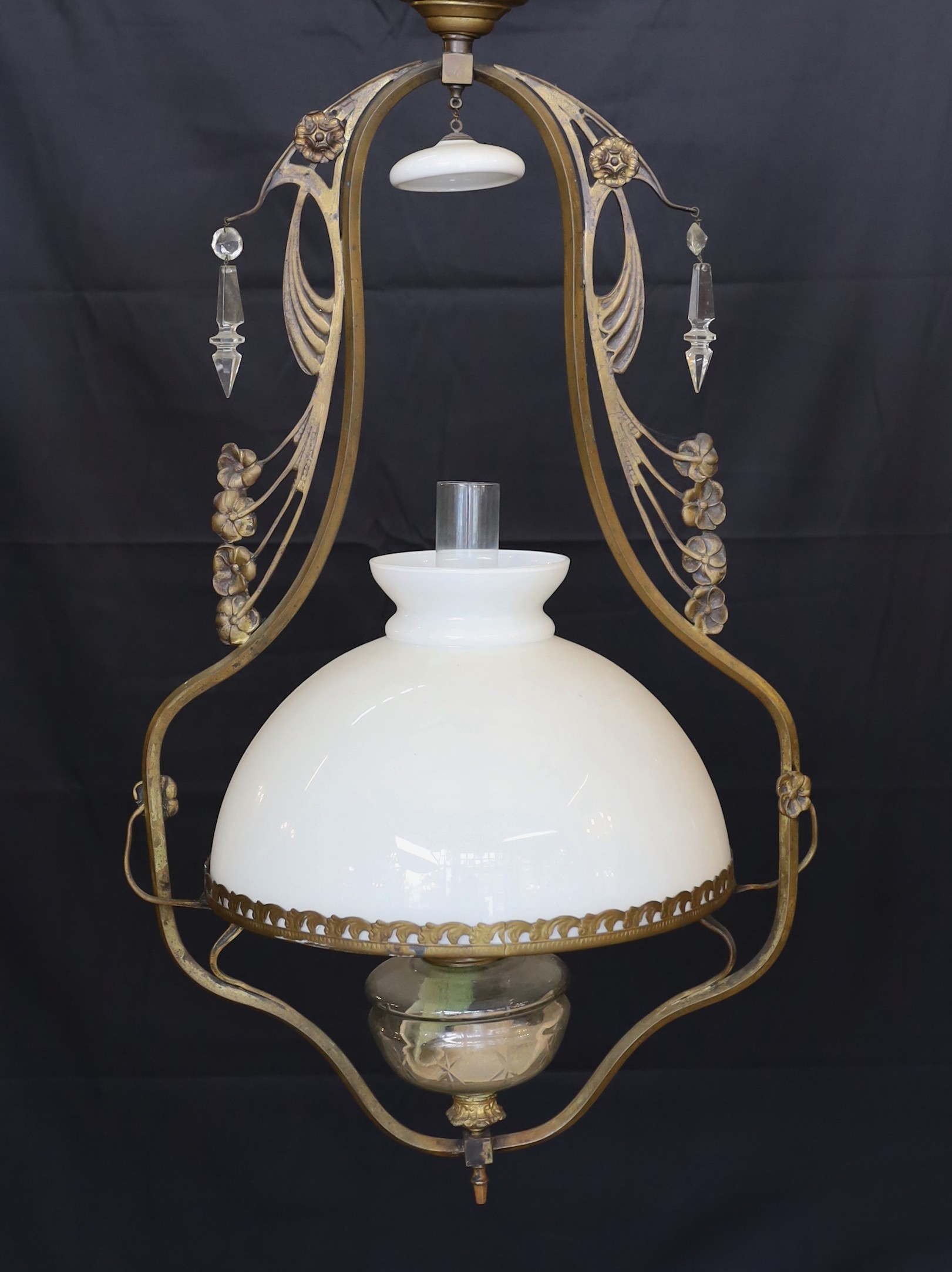 A late 19th century French bronze and cut glass hanging oil lamp with opaque glass shade, drop