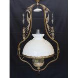 A late 19th century French bronze and cut glass hanging oil lamp with opaque glass shade, drop