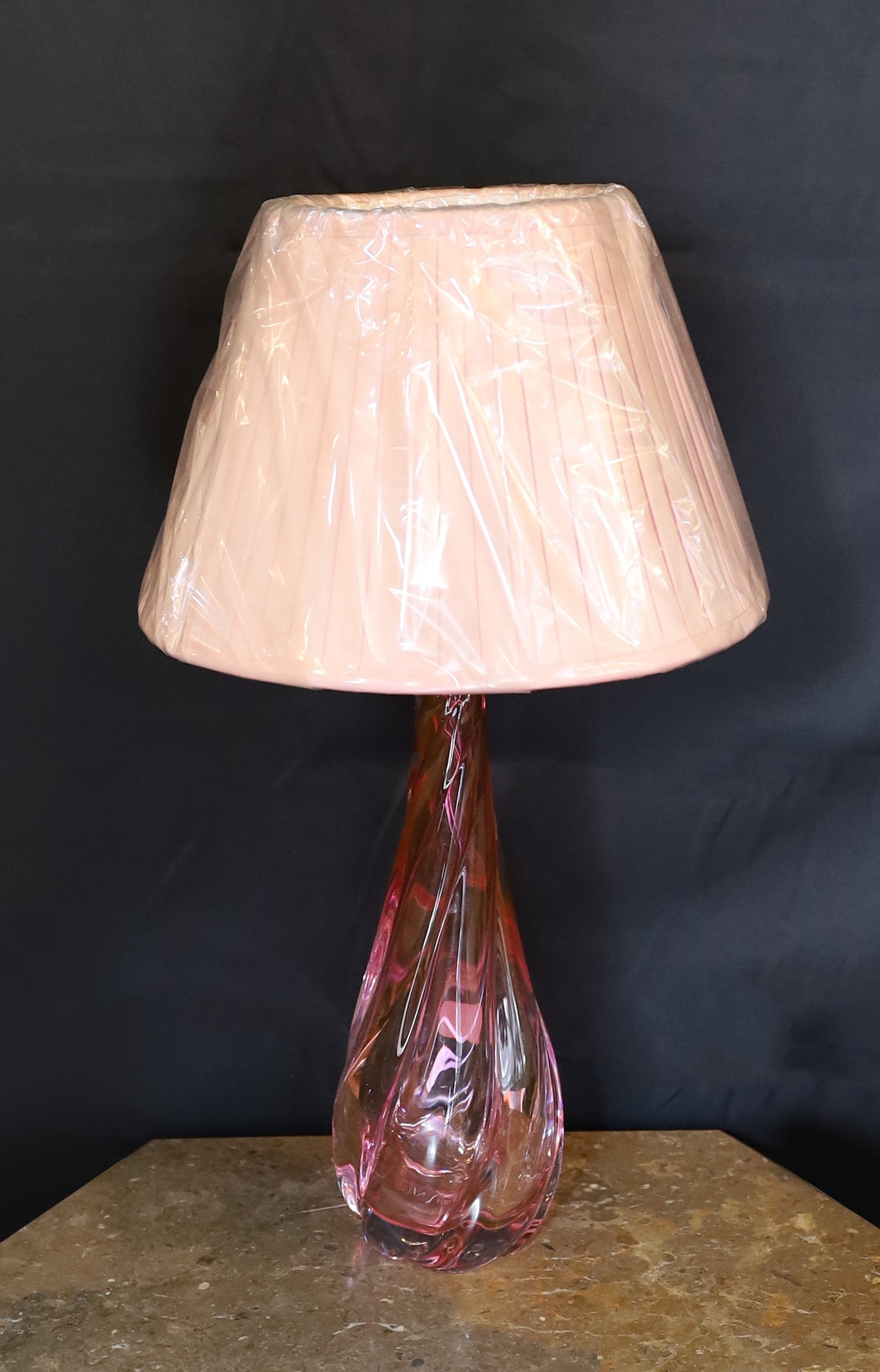 A 1960s Val Saint Lambert cranberry tinted glass table lamp, of twisted form, with replacement