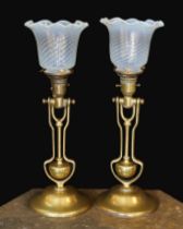 A pair of brass Pullman lamps with gimbal stems and Vaseline glass shades, modelled for wall