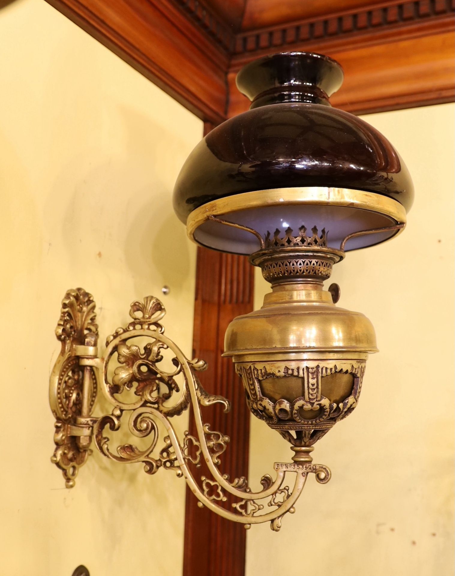 A pair of Victorian brass wall mounted oil lamps, with swivelling foliate pierced branches and - Image 2 of 4