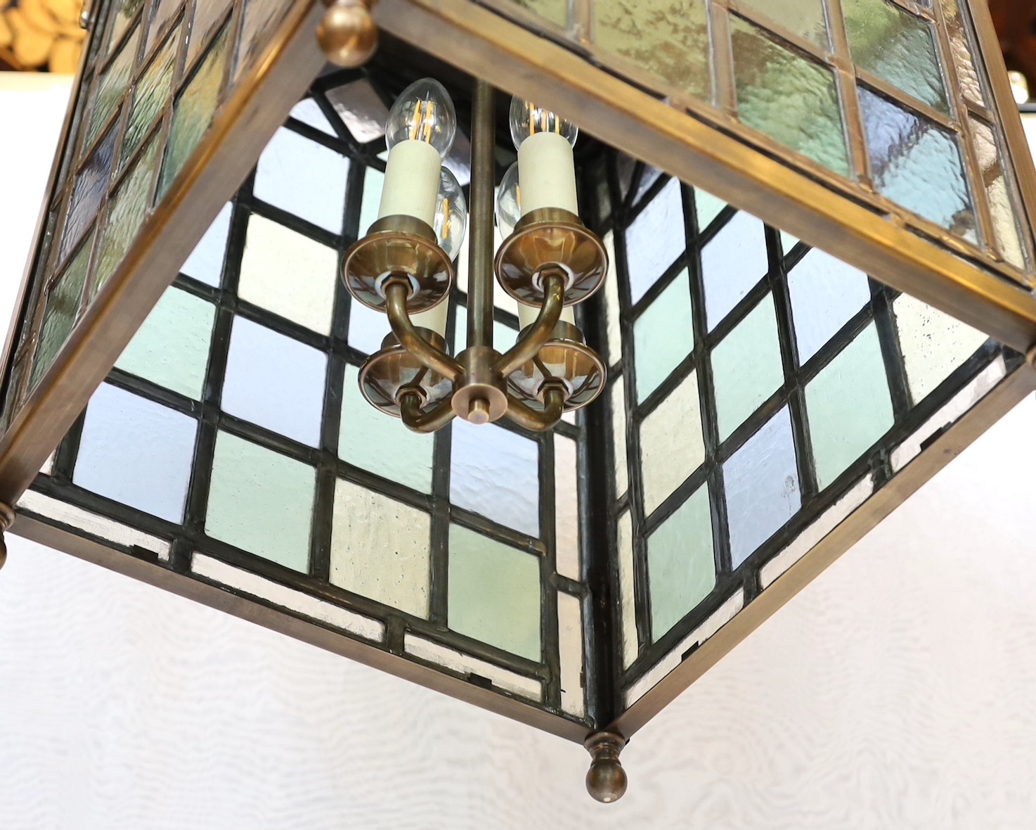 A large Edwardian lacquered brass and leaded glass hall lantern applied with rams head motifs, - Image 4 of 4