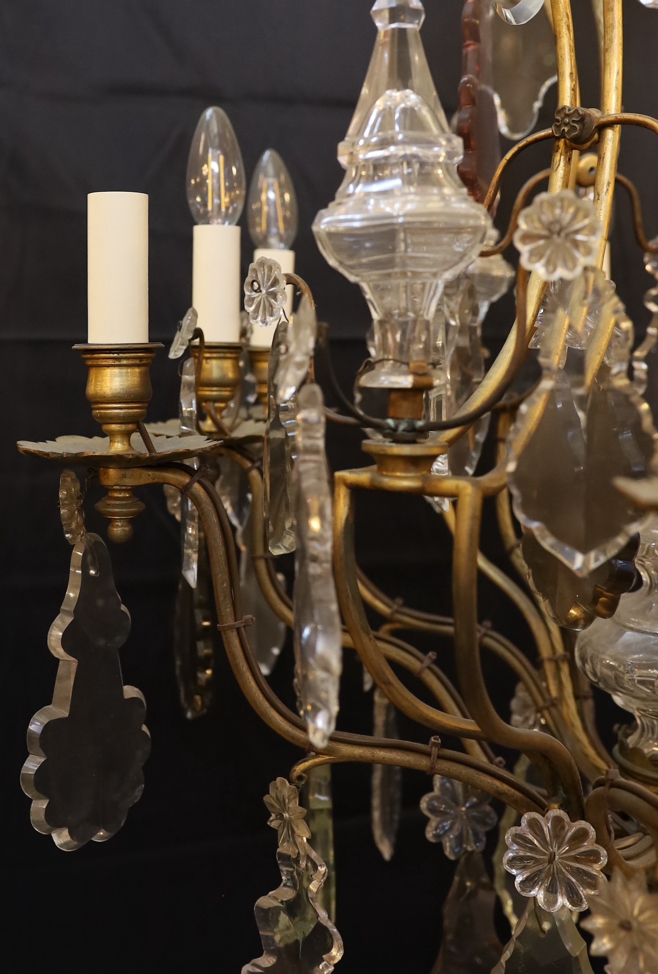 An early 20th century French gilt bronze and cut glass eight light chandelier profusely hung with - Image 3 of 4