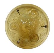 A 1920s French moulded amber glass light bowl, decorated with roses, with chain set and ceiling