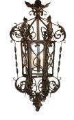 An early 20th century English black painted wrought iron hexagonal hall lantern, drop 92cm. width