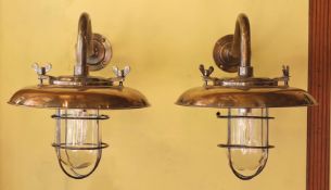 A pair of nautical style bronzed metal wall lights, height 35cm. diameter 35cm***CONDITION