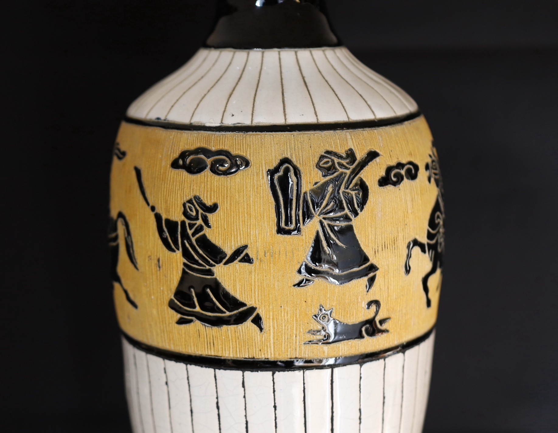 A 20th century Continental tinglazed pottery table lamp, decorated within a band of horse riders and - Image 2 of 5