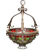 An English Arts & Crafts wrought iron and stained glass basket shaped light fitting, height 70cm