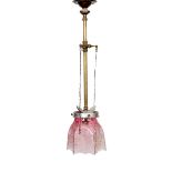 An early 20th century English brass gasoline light fitting, converted to electricity, with pink