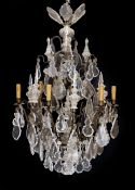 An early 20th century French bronze and cut glass six light chandelier, of particularly ornate