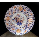 An Imari charger decorated with a central panel of flowers in a vase within floral borders, diameter