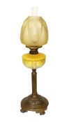 A Victorian brass oil lamp with opaque yellow glass reservoir, duplex mechanism, etched glass
