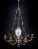 A 1930s English bronze and porcelain six light chandelier with central foliate stem and three oval