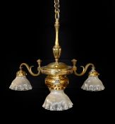 An Edwardian lacquered brass three light chandelier with ribbed glass shades, height 70cm. width