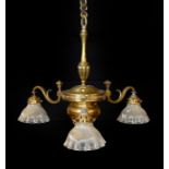 An Edwardian lacquered brass three light chandelier with ribbed glass shades, height 70cm. width