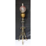 A late Victorian Arts and Crafts wrought iron and brass miniature oil lamp standard, in the manner