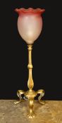 An early 20th century English brass table lamp with associated tinted and frosted glass shade,