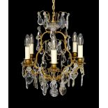 An early 20th century French gilt bronze and cut glass six light chandelier, height 54cm. width