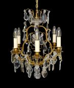 An early 20th century French gilt bronze and cut glass six light chandelier, height 54cm. width