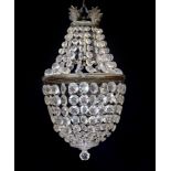 An early 20th century bronze and beaded crystal bag shaped chandelier with graduated octagonal cut