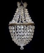 An early 20th century bronze and beaded crystal bag shaped chandelier with graduated octagonal cut