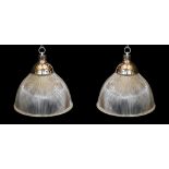 A pair of industrial style chrome plated ceiling lights with ribbed glass shades, signed Endural,