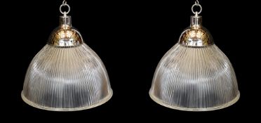A pair of industrial style chrome plated ceiling lights with ribbed glass shades, signed Endural,