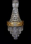 An early 20th century English ormolu and cut glass bag chandelier, hung with octagonal cut drops and