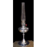 A 1930s nickel plated oil lamp with plain glass flue, height overall 68cm